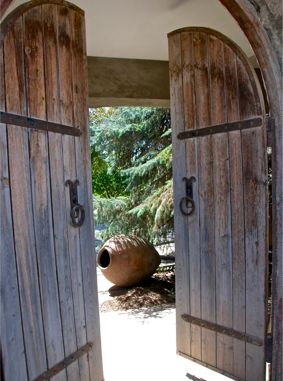 The winery's old wooden doors open onto a clay karas in the courtyard