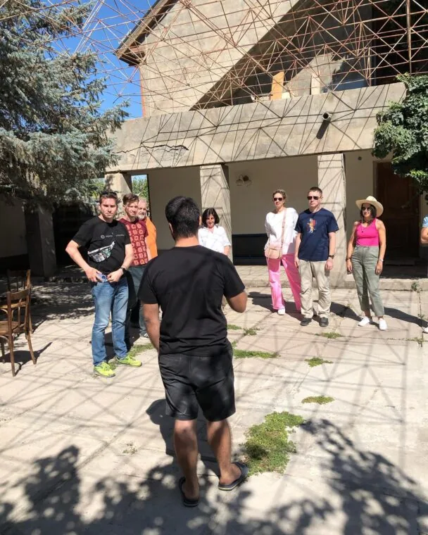 Hayk guiding visitors through the courtyard